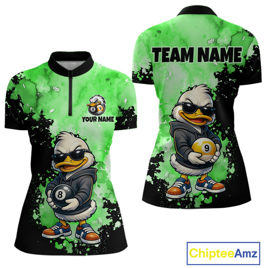Front and back views of a women's short-sleeve polo shirt featuring a cartoon duck character in a black hoodie holding pool balls, on a green and black splatter background. The front has a half-zip collar and customizable text/logo area, while the back shows 'TEAM NAME' text.