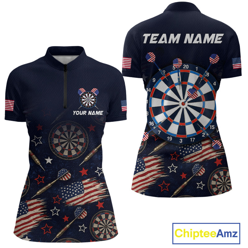 Front and back views of a women's short-sleeve quarter-zip polo shirt in navy blue, featuring a patriotic American flag and dartboard theme with stars, stripes, darts, and a large dartboard graphic on the back. The back also has 'TEAM NAME' printed across the shoulders.