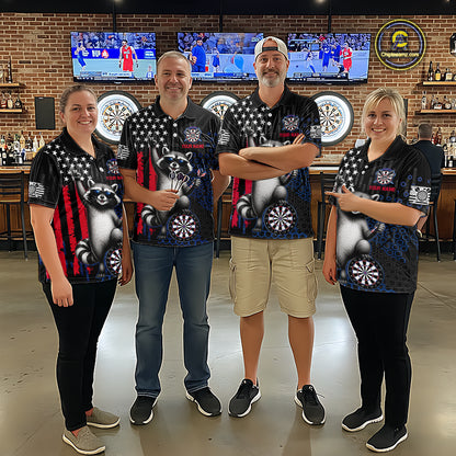 Four people standing together in a bar wearing matching black short-sleeve polo shirts with a graphic design featuring a raccoon, stars, and red and white vertical stripes. The background shows a brick wall, bar shelves, and mounted sports screens.