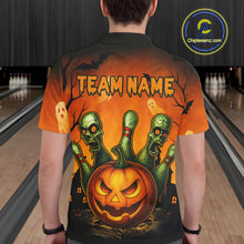 Load image into Gallery viewer, Person wearing a Halloween-themed shirt with a pumpkin and zombie design in a bowling alley.