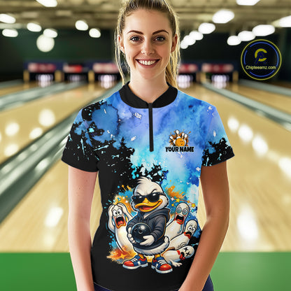 Person wearing a colorful bowling shirt with cartoon characters in a bowling alley.