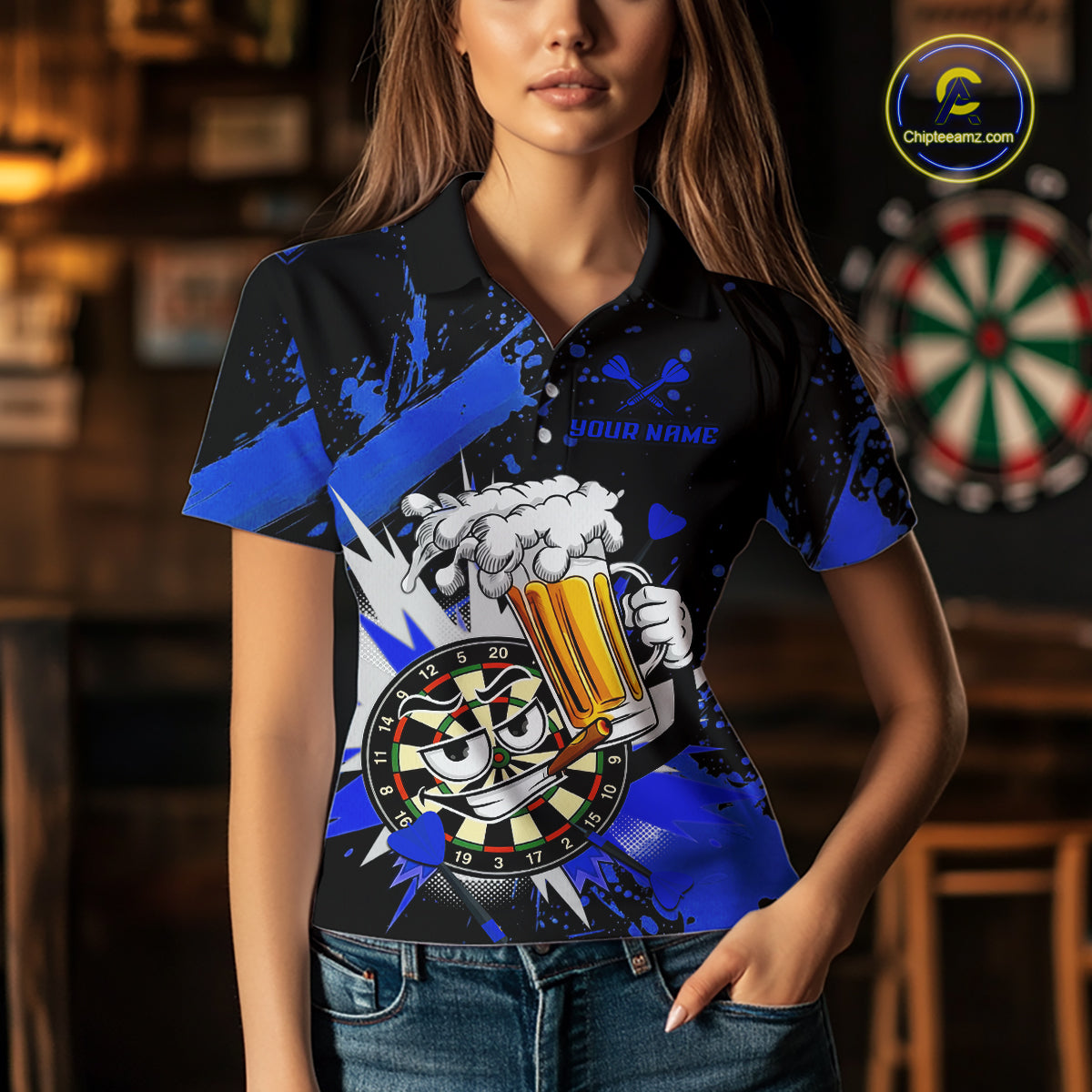 A woman wearing a black short-sleeve polo shirt with a bright blue and white graphic design featuring a cartoon dartboard and beer mug, set against a blurred bar background.