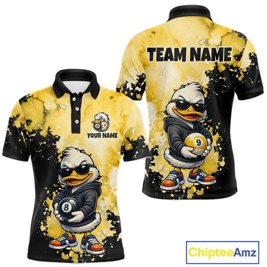 Customizable short-sleeve polo shirt shown from the front and back, featuring a cartoon duck mascot wearing sunglasses and holding pool balls, with a yellow and black splatter design. The front shows 'YOUR NAME' and the back shows 'TEAM NAME' placeholders.