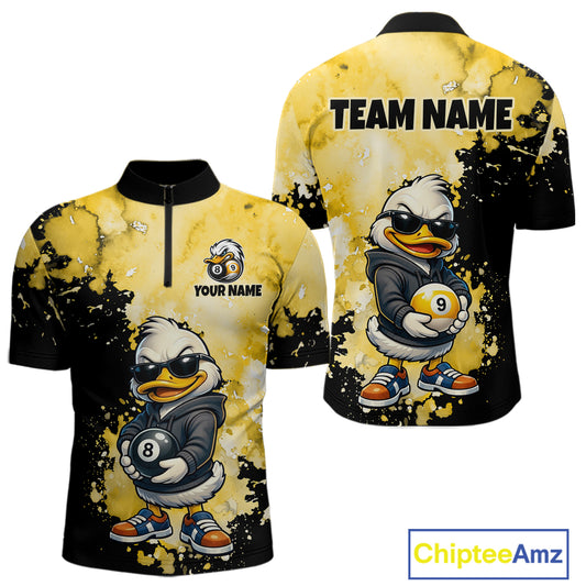Front and back views of a short-sleeve quarter-zip performance shirt featuring a cartoon duck mascot in a black hoodie holding pool balls, on a yellow and black splatter background. The front shows placeholder text 'YOUR NAME' and 'TEAM NAME' on the back.