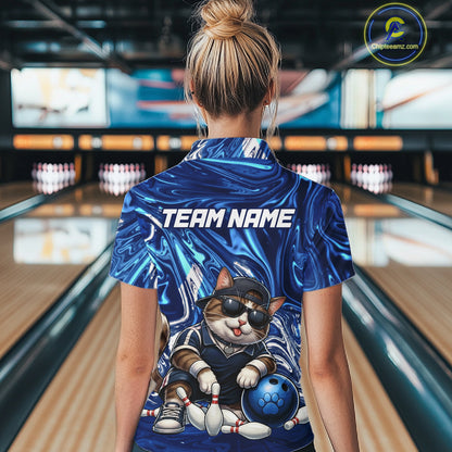 Person wearing a blue bowling shirt with a cat design and 'TEAM NAME' text in a bowling alley.