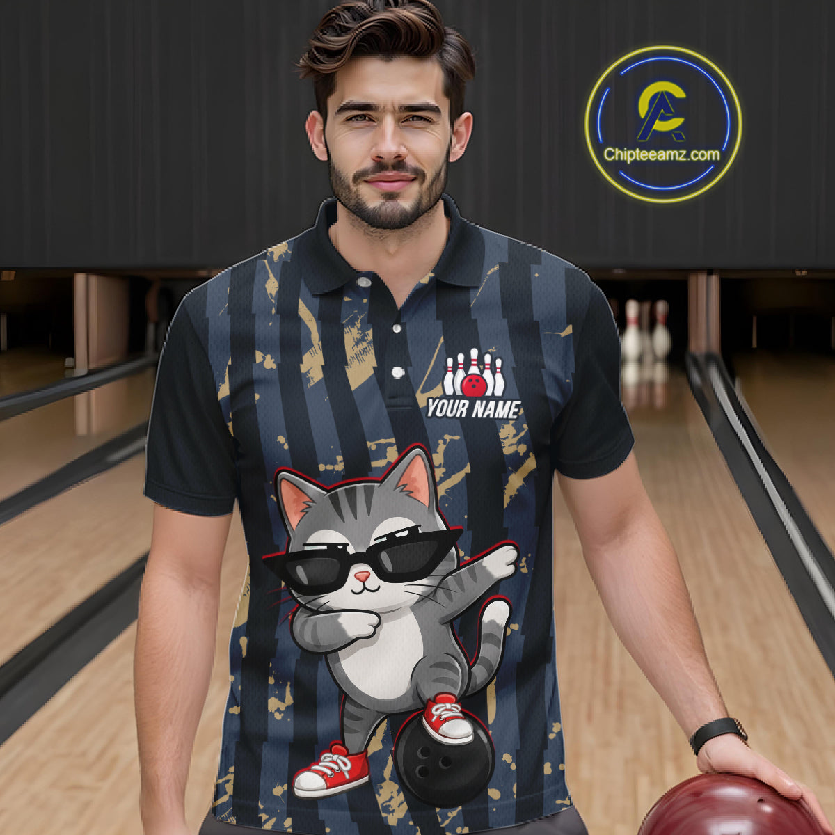 Man wearing a bowling-themed shirt with a cat design in a bowling alley.