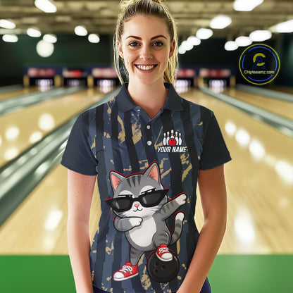 Woman wearing a bowling shirt with a cat design in a bowling alley.