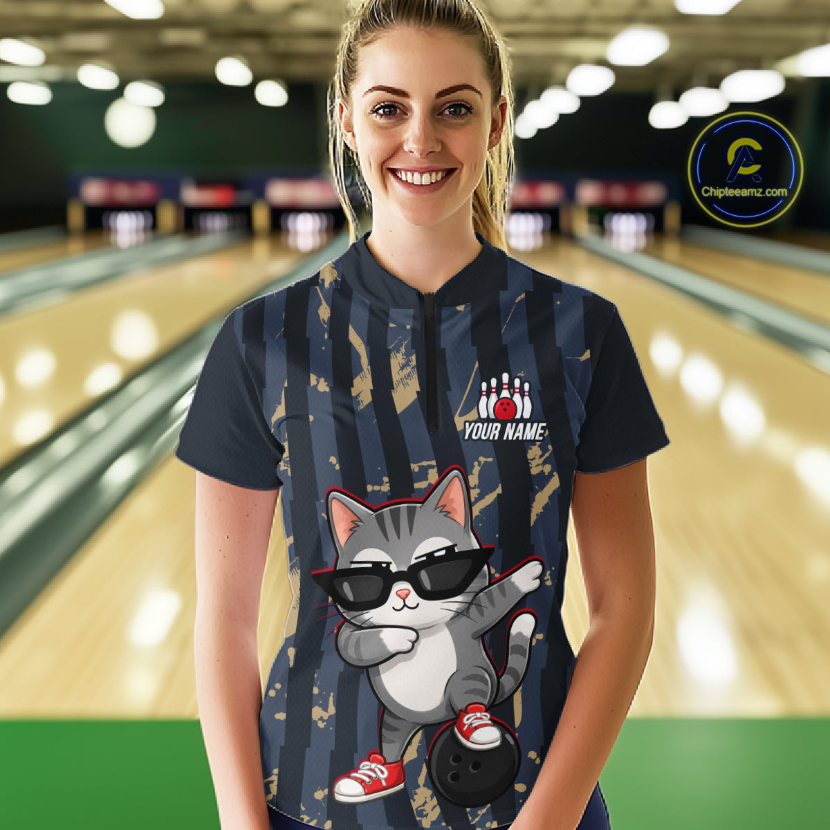 Person wearing a bowling shirt with a cat graphic and customizable text in a bowling alley.