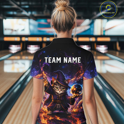 Person wearing a colorful shirt with a cat wizard design in a bowling alley.