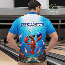 Load image into Gallery viewer, Person wearing a blue t-shirt with a lobster graphic and 'TEAM NAME' text in a bowling alley.