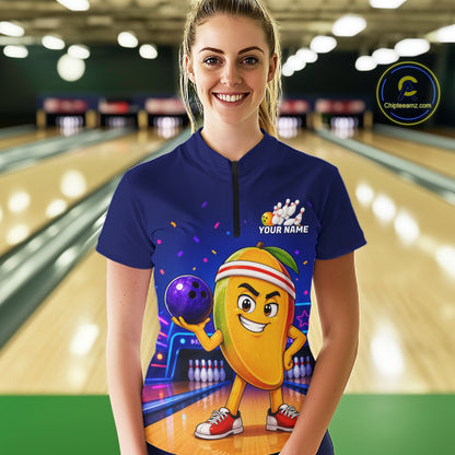 Person wearing a blue bowling shirt with a colorful design in a bowling alley.