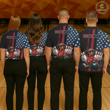 Load image into Gallery viewer, Four people wearing matching bowling-themed shirts with an American flag design on a bowling alley.