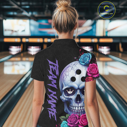Person wearing a black bowling shirt with a colorful skull design in a bowling alley.