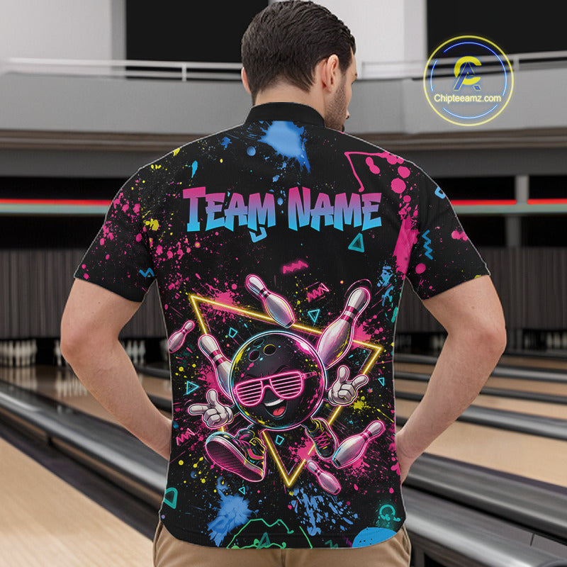 A man viewed from behind wearing a black short-sleeve bowling-themed shirt with a colorful neon graphic of bowling pins, a bowling ball, and the text 'TEAM NAME' on the back. The background shows bowling lanes.