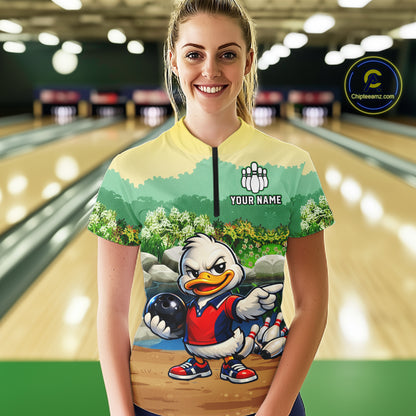 Person wearing a colorful bowling shirt with a cartoon character on a bowling alley.