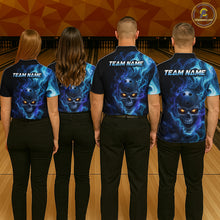Load image into Gallery viewer, Four people wearing matching blue and black shirts with a skull design on a bowling alley.