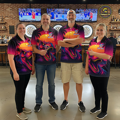 Four people wearing darts polo shirt featuring a dinosaur holding a dartboard with sunset and palm tree artwork on a colorful background.