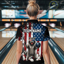 Load image into Gallery viewer, Women’s us flag raccoon bowling polo shirt, back view on female model in bowling lane 