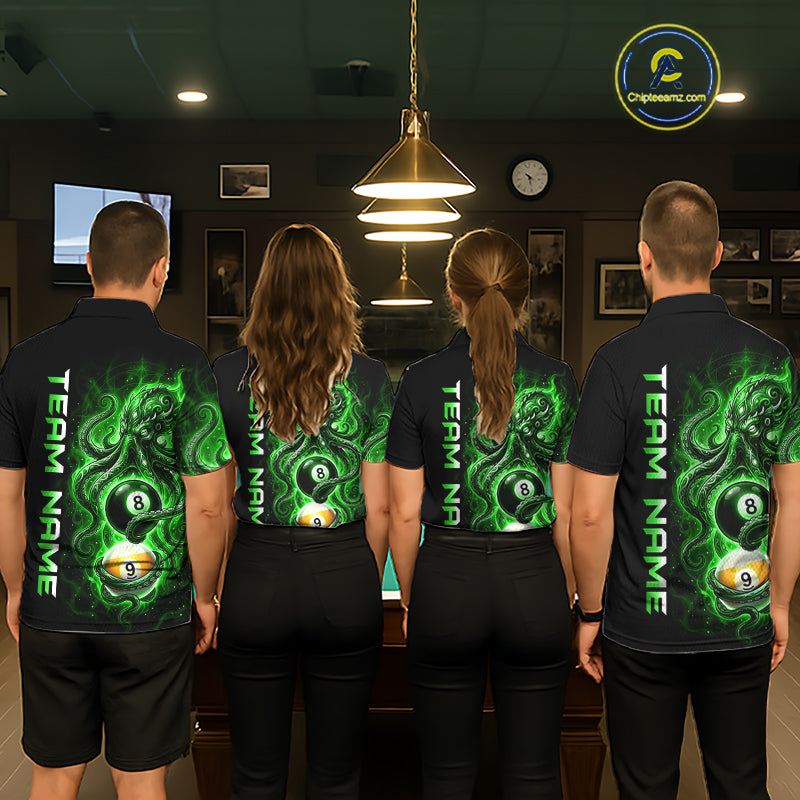 Four people wearing black shirts with green and white designs, standing in a room with a pool table.