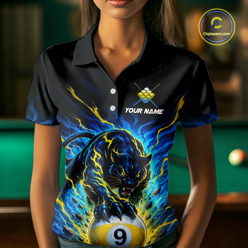 Person wearing a black polo shirt with a panther and pool ball design, with a blurred pool table in the background.