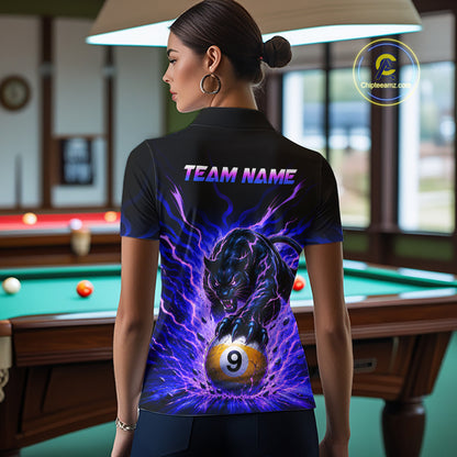 Person wearing a black t-shirt with a purple and blue design featuring a panther and number 9 ball, in a pool hall.