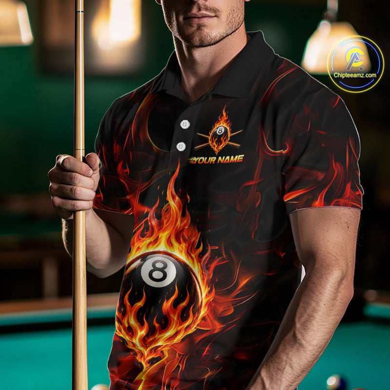 Man wearing a black shirt with a fire-themed design holding a pool cue in a billiards setting.