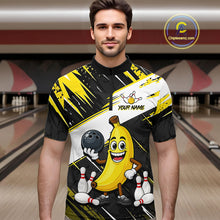 Load image into Gallery viewer, Man wearing a bowling-themed shirt with a banana character in a bowling alley.