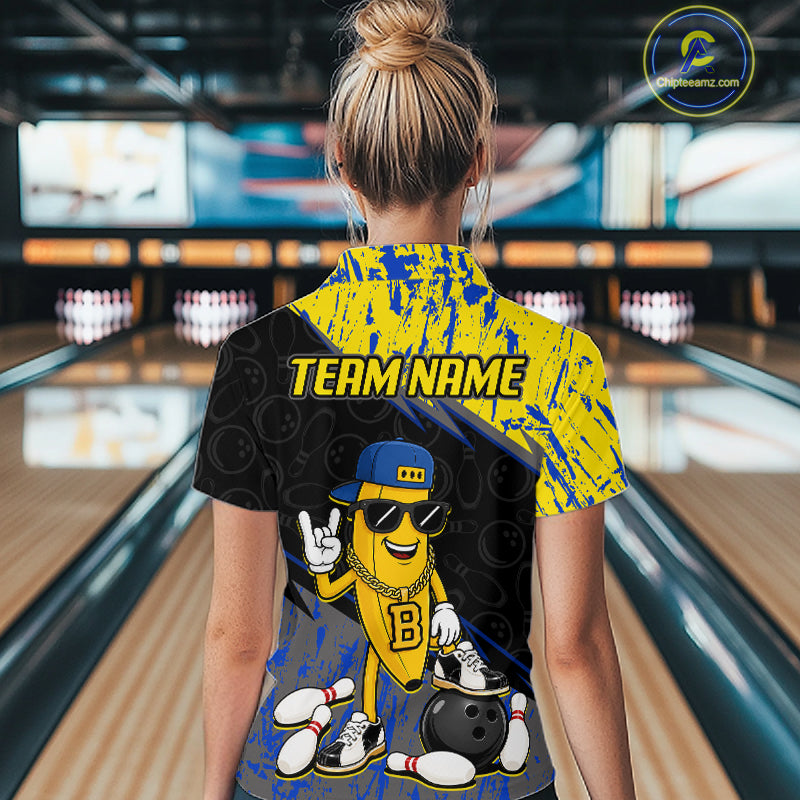 Women polo wearing a bowling shirt with a cartoon character and 'TEAM NAME' text in a bowling alley.