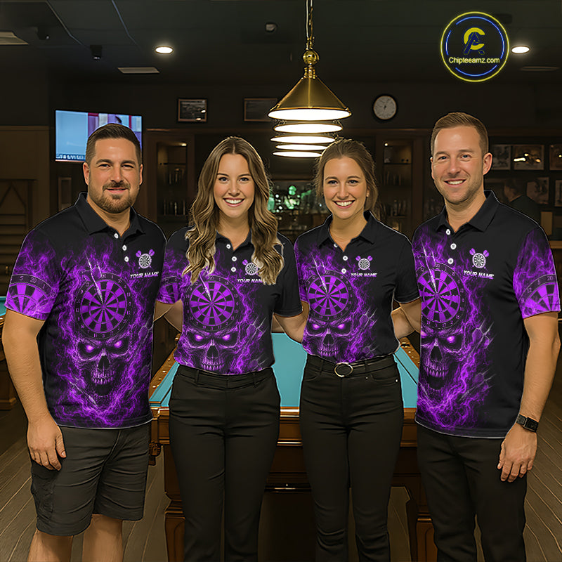 Four people standing together in a bar or lounge setting, wearing matching black polo shirts with a vivid purple skull and dartboard graphic print. The shirts also feature a small crest logo and the text 'YOUR NAME' and 'TEAM NAME'.