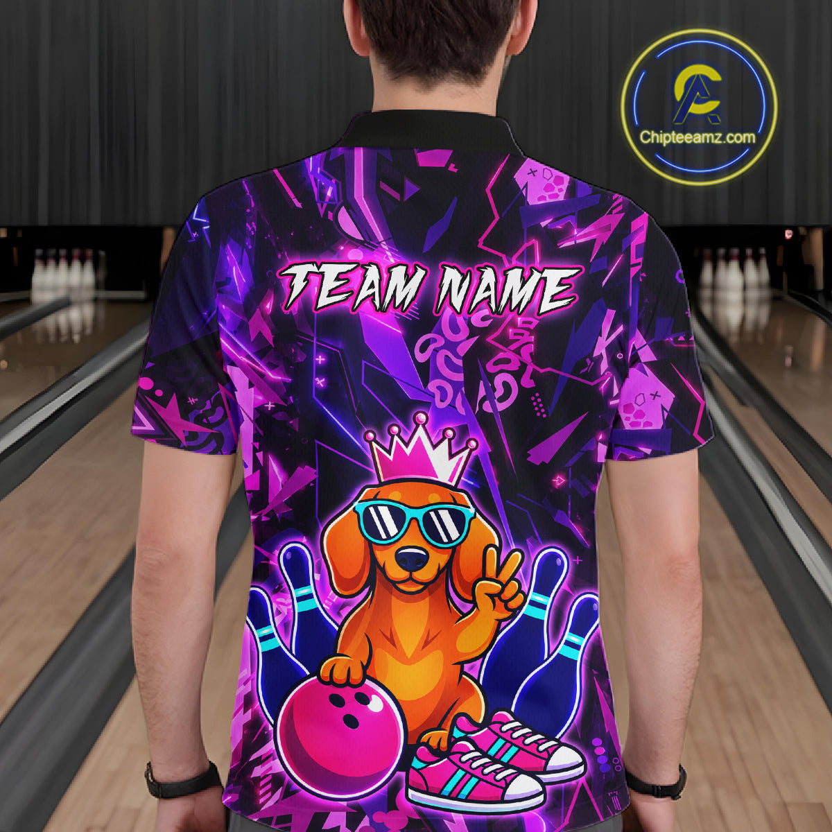 Men wearing a black and purple bowling polo shirt featuring a cartoon dachshund wearing sunglasses and a crown, holding a pink bowling ball, with custom team and player name text.