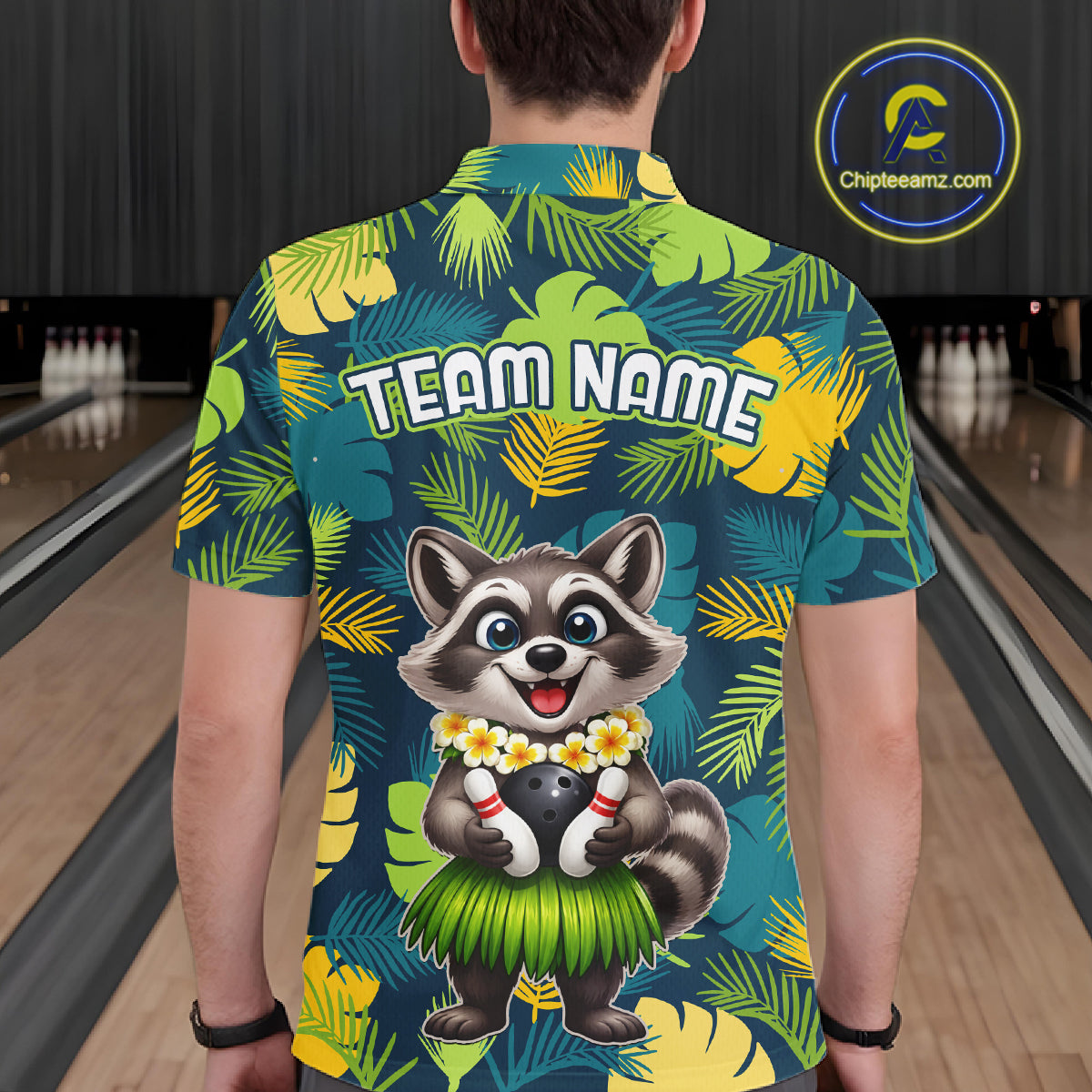 Man wearing a tropical bowling polo featuring a smiling raccoon mascot in a grass skirt, leafy patterns, bowling pins, and custom team name text.
