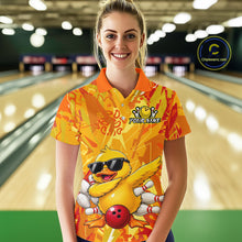 Load image into Gallery viewer, Person wearing a colorful bowling shirt with a duck design in a bowling alley.