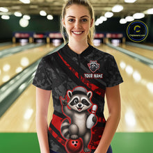 Load image into Gallery viewer, Person wearing a black bowling shirt with a raccoon graphic in a bowling alley.