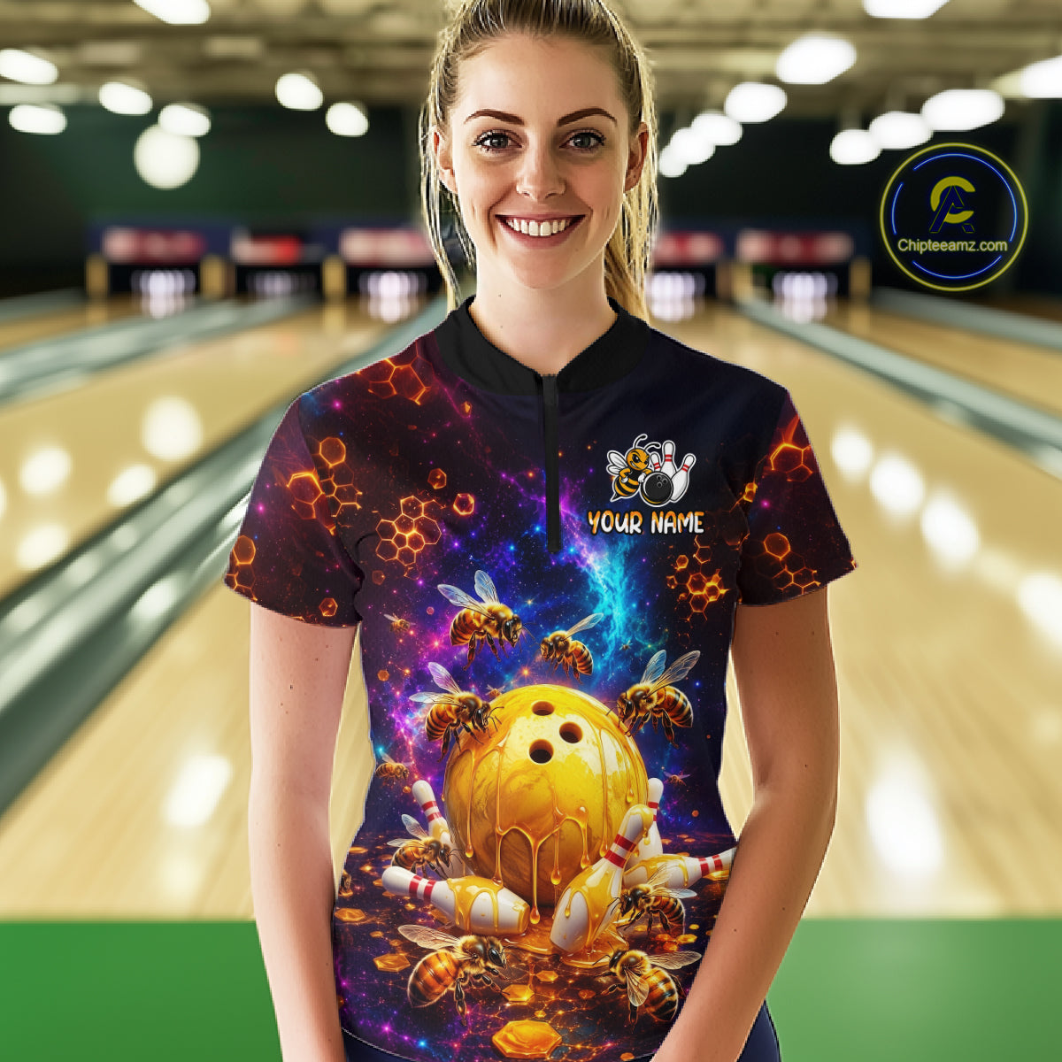 Woman wearing of a dark bowling quarter zip with cosmic honeycomb graphics, bees, honey-dripping bowling balls, pins, and custom your name text.