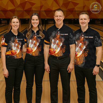 Four people standing together in a bowling alley wearing matching black short-sleeve bowling shirts with a large bowling pin and ball flame graphic on the front, paired with black pants.