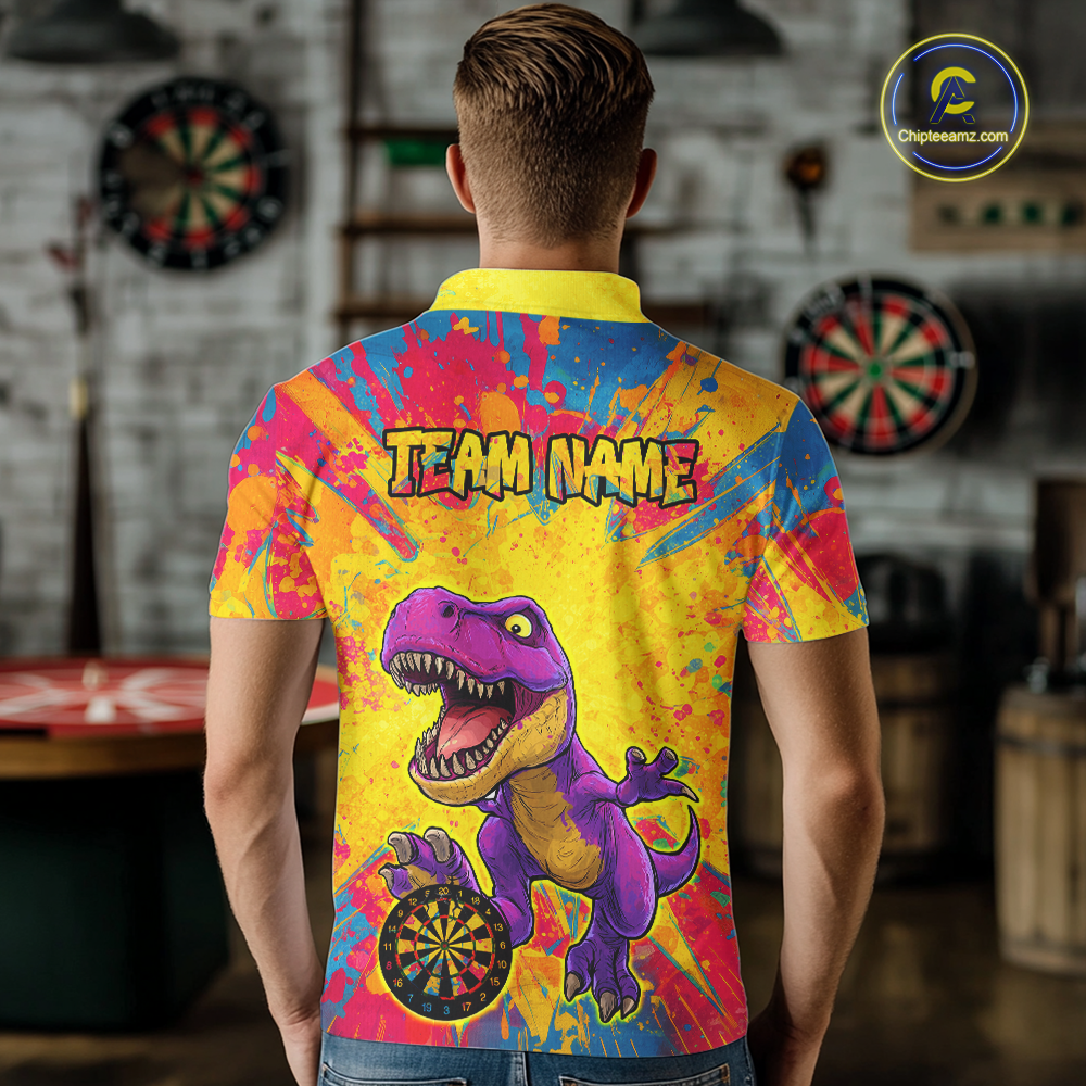 Man wearing darts polo shirt featuring a purple dinosaur holding a dartboard within a bright colorful paint splatter background.