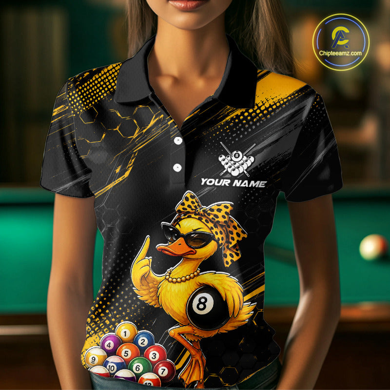 Women wearing billiards polo shirt featuring a duck holding an eight ball with pool balls arranged across a black yellow background.