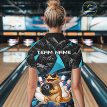 Load image into Gallery viewer, Women’s turquoise bearded dragon bowling polo shirt, back view on female model in bowling lane 