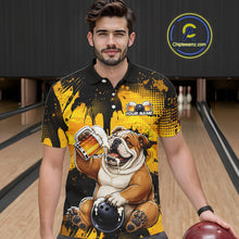 Load image into Gallery viewer, Man wearing a black and yellow polo shirt with a bulldog graphic in a bowling alley.