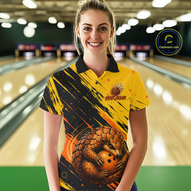 A woman standing in a bowling alley wearing a yellow and black short-sleeve bowling shirt with a large pangolin graphic on the front and a visible 'ChipteeAmz' watermark in the upper right.