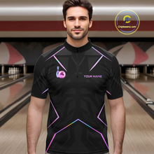 Load image into Gallery viewer, Man wearing a black bowling shirt with colorful designs in a bowling alley.