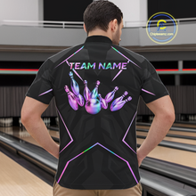 Load image into Gallery viewer, Person wearing a black bowling shirt with colorful designs and 'TEAM NAME' text in a bowling alley.