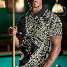 Load image into Gallery viewer, Man holding a pool cue while wearing a black and gold polo shirt covered in intricate Polynesian-inspired tribal patterns and a large crowned 8-ball graphic near the hem.