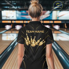 Load image into Gallery viewer, Woman wearing a black bowling shirt with gold pins design and 'TEAM NAME' text in a bowling alley.