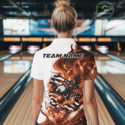 Female model back view at the bowling lane wearing a white and orange quarter zip shirt with eagle graphics and flag inspired artwork.