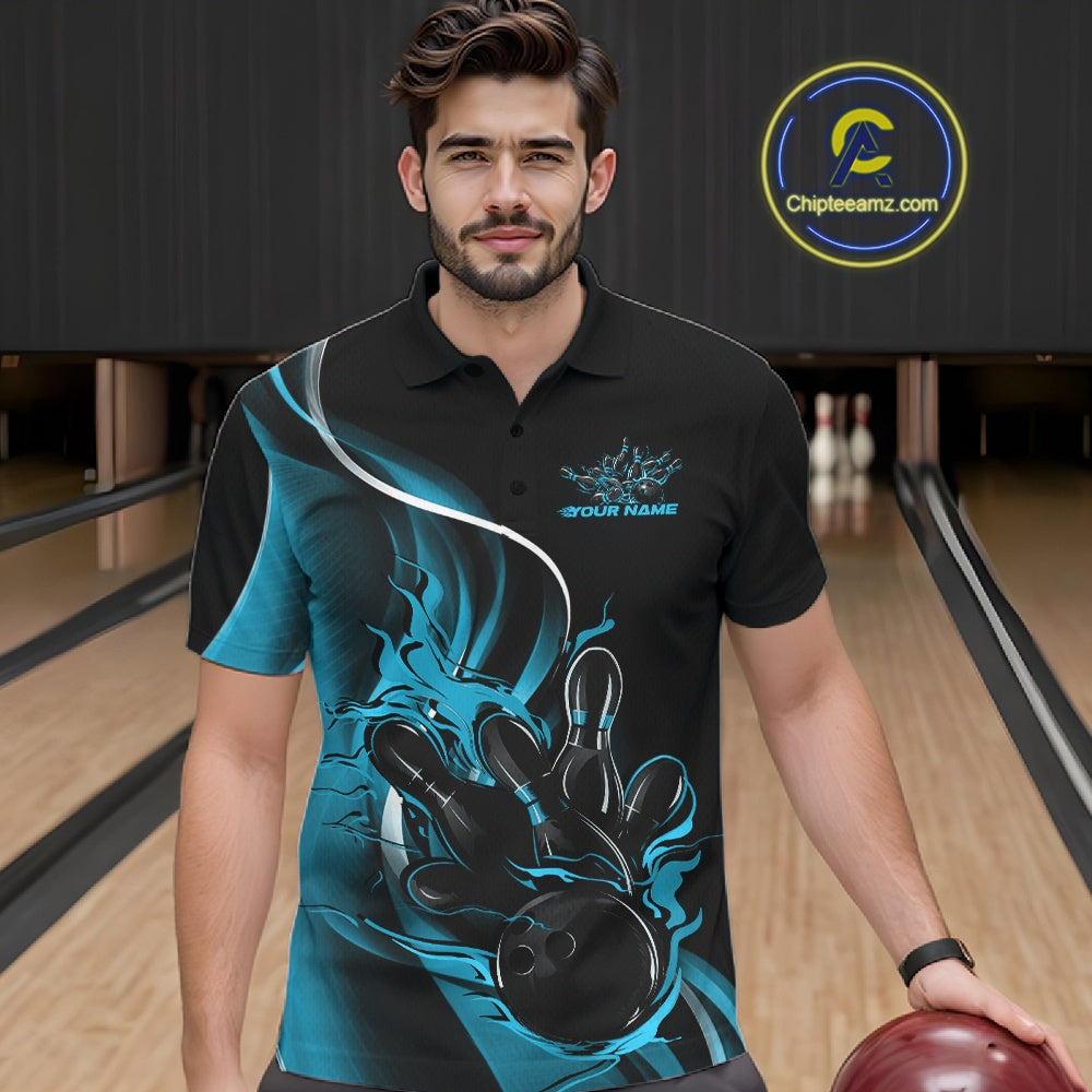 Male model seen from the front in a bowling lane wearing a black and blue polo shirt featuring a flame bowling ball striking pins in a dynamic sports action scene.