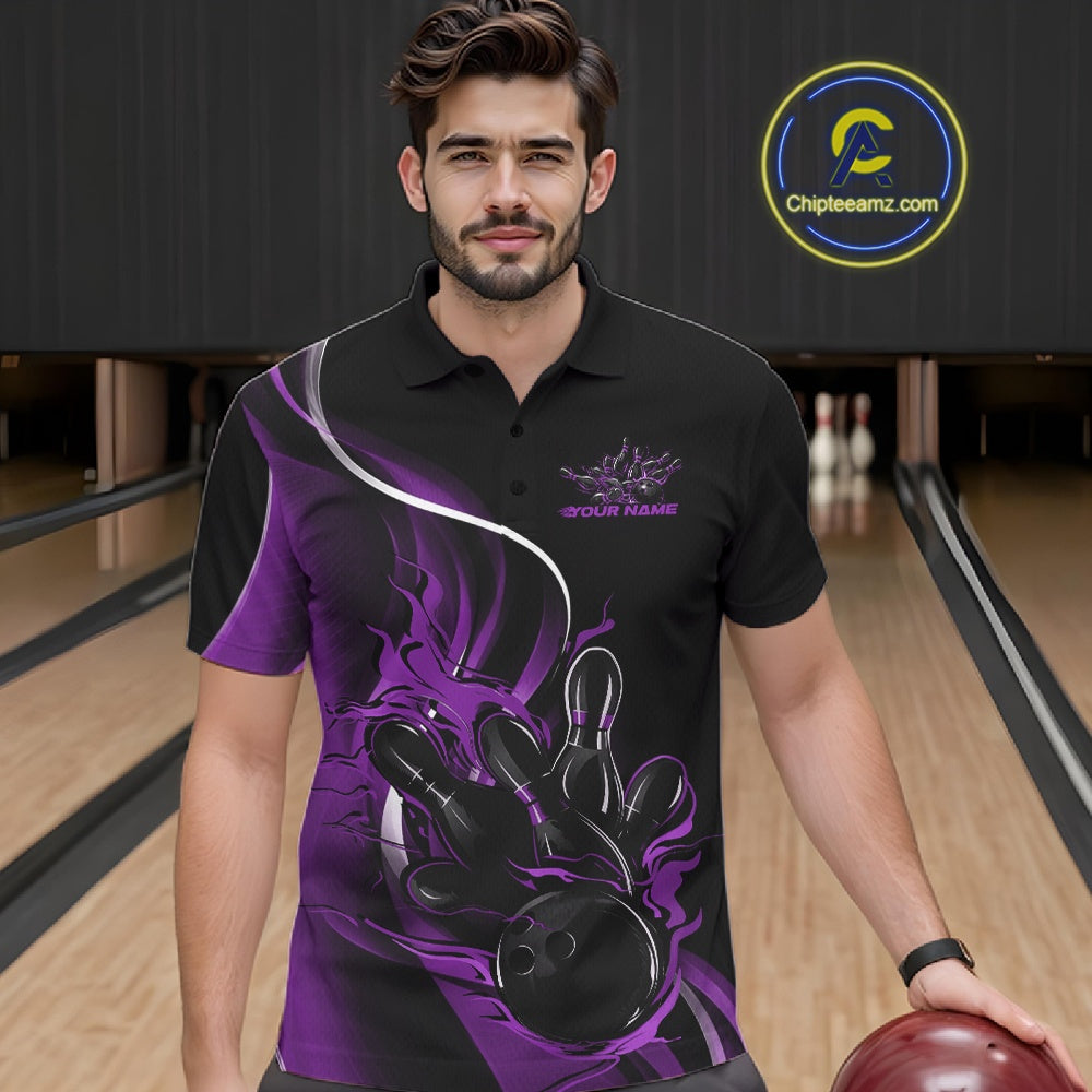 Male model seen from the front in a bowling lane wearing a black and purple polo shirt featuring a flame bowling ball striking pins in a dynamic sports scene.