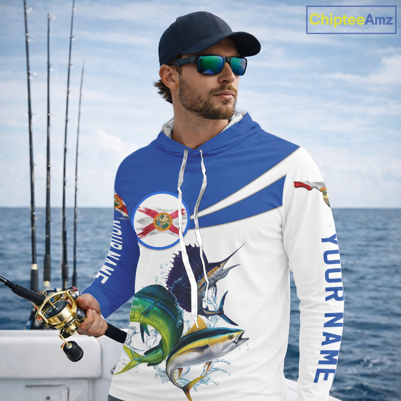 Man wearing a fishing-themed hoodie with ocean and fishing rods in the background