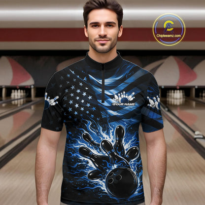 Male model wearing a black bowling quarter-zip shirt at the lane with blue flame bowling artwork and flag-inspired elements.