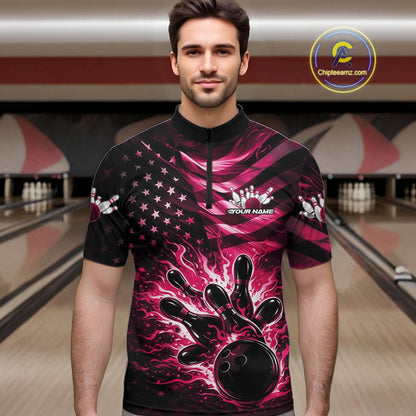 Male model wearing a black bowling quarter-zip shirt at the bowling lane with pink flame bowling graphics and patriotic flag accents.